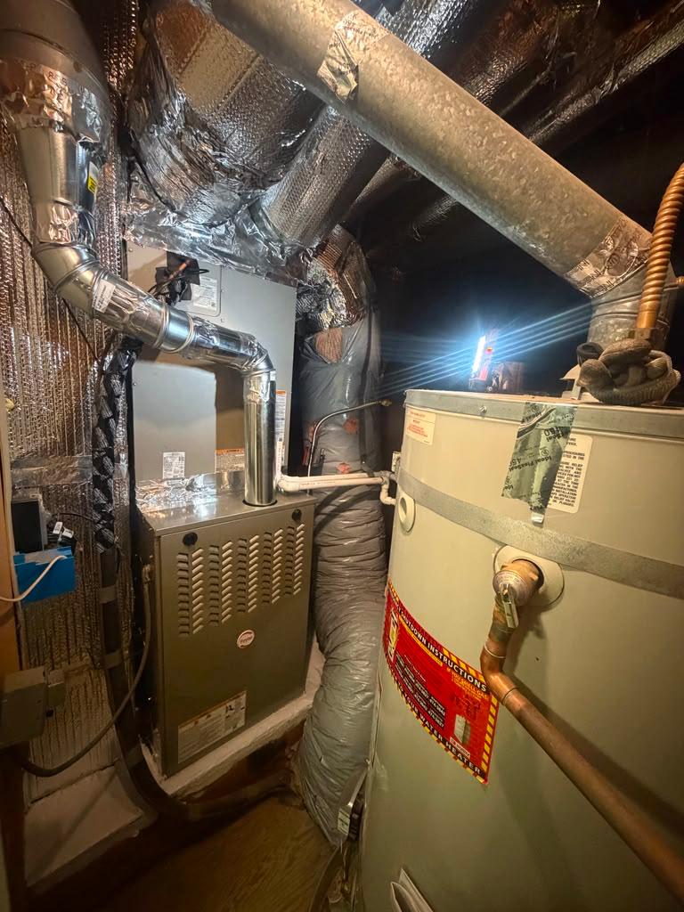 Residential indoor furnace and insulated air duct work installation in utility room